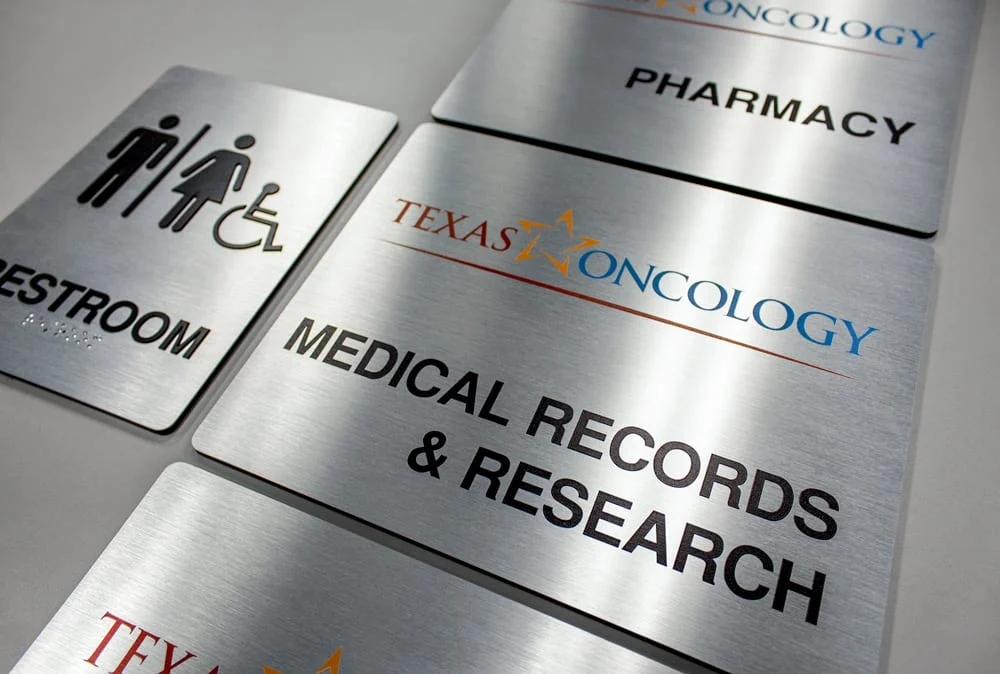 Custom interior wayfinding signage for commercial building room identification and ADA compliance.