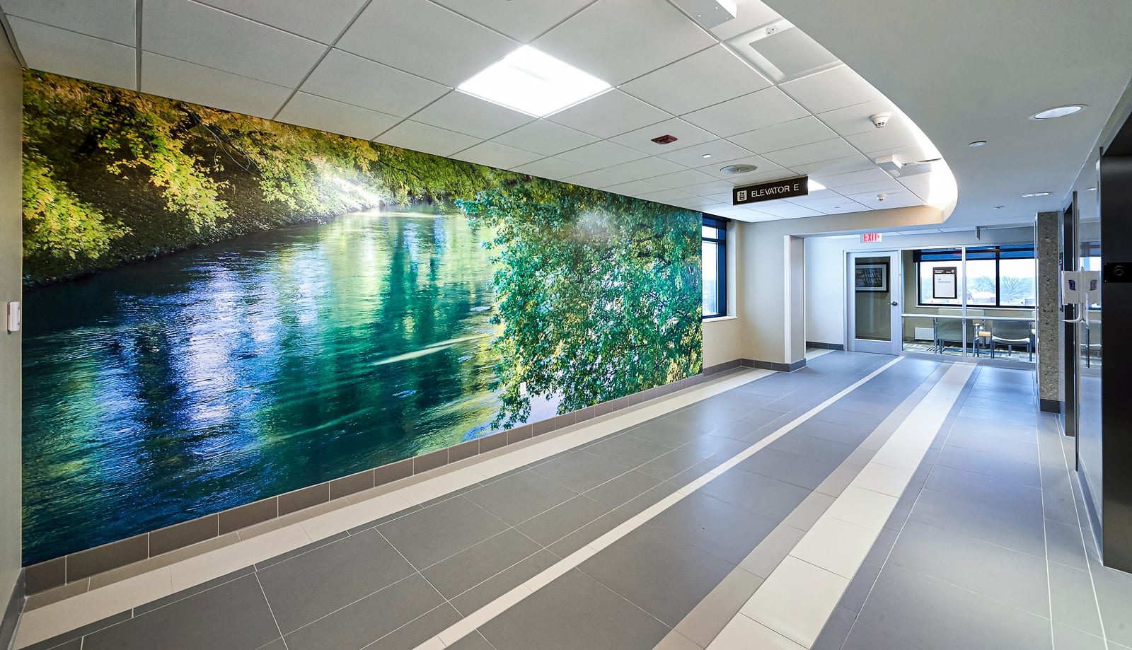 A hospital elevator lobby features a custom wall graphic to assist with wayfinding and navigation.
