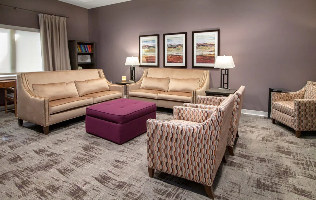 Framed artwork in this shared senior living space contributes to a warm and inviting environment.