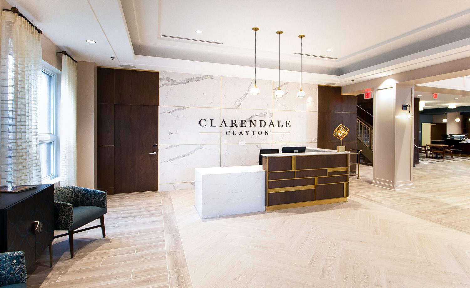 Senior living reception area features a custom dimensional logo from ARCH Design.