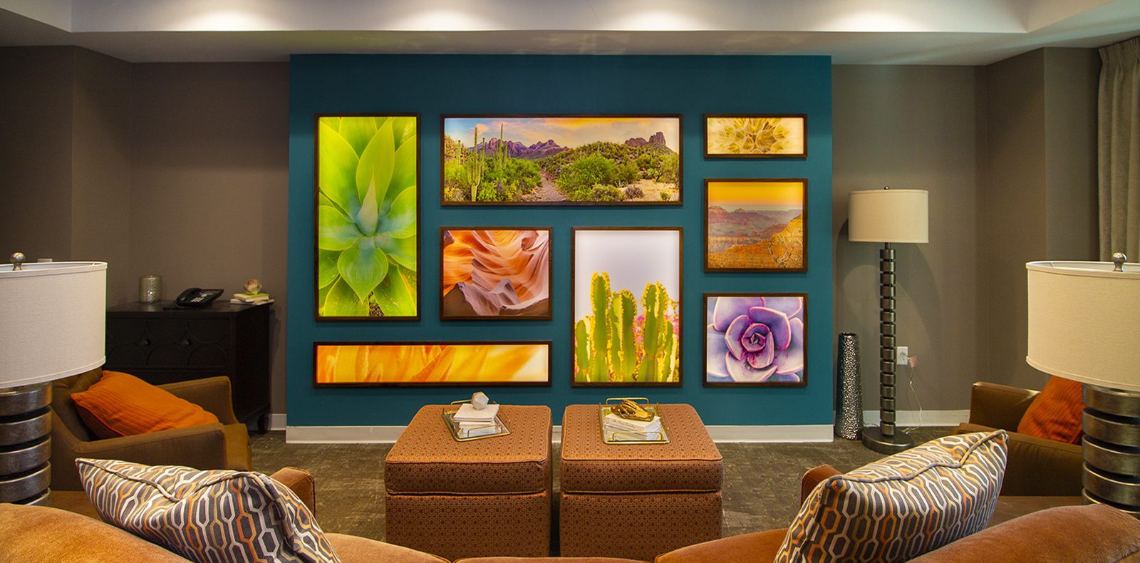A senior living lounge features illuminated art with soft backlighting to enhance the custom artwork display.
