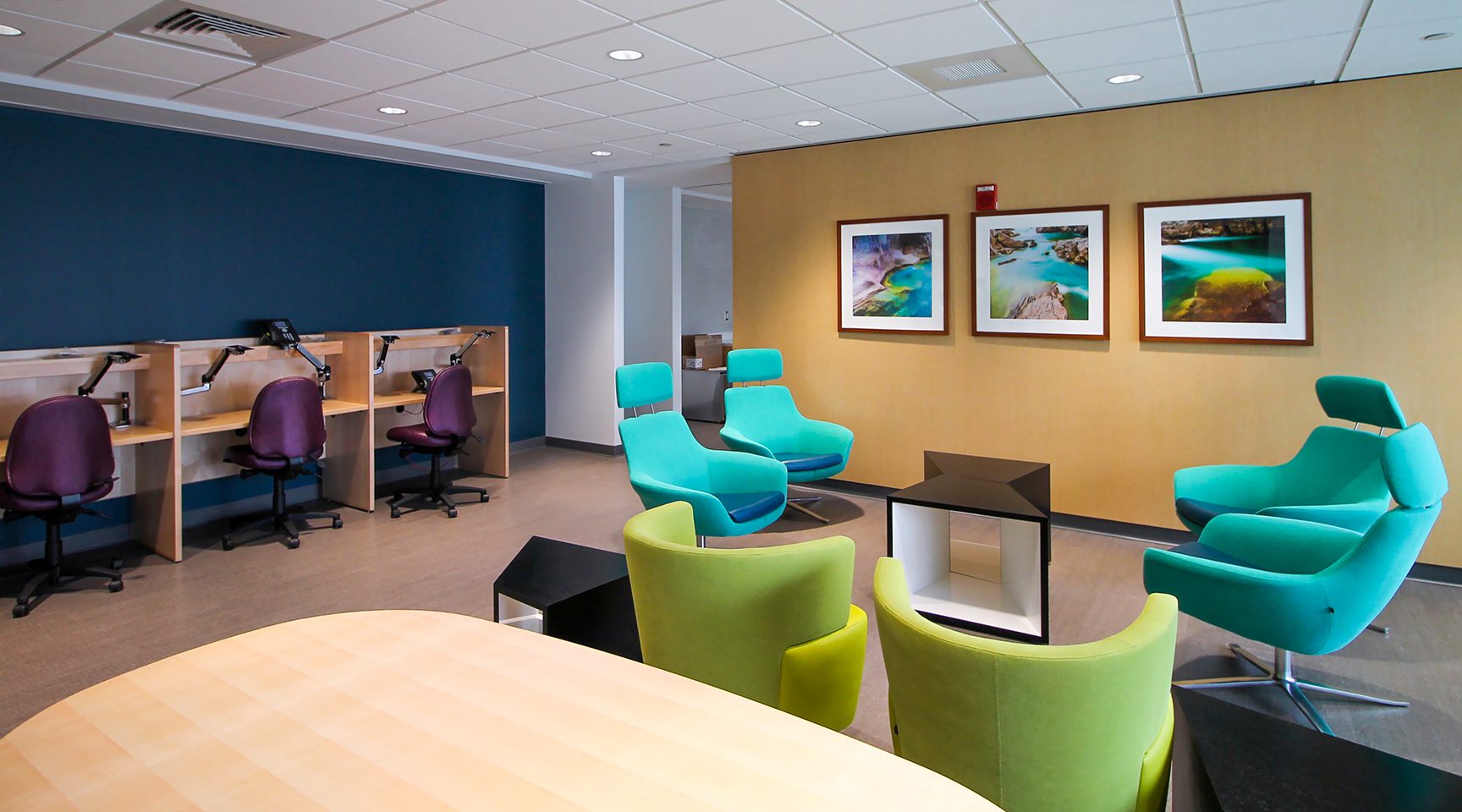 Framed nature art coordinates with the vibrant color scheme in a hospital doctor's lounge.