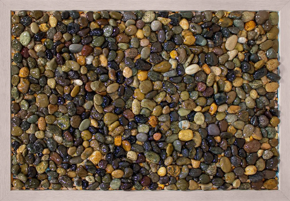 Custom tactile art featuring smooth pebbles resembles Lake Michigan stones, sparking memories and reflection among memory care residents.