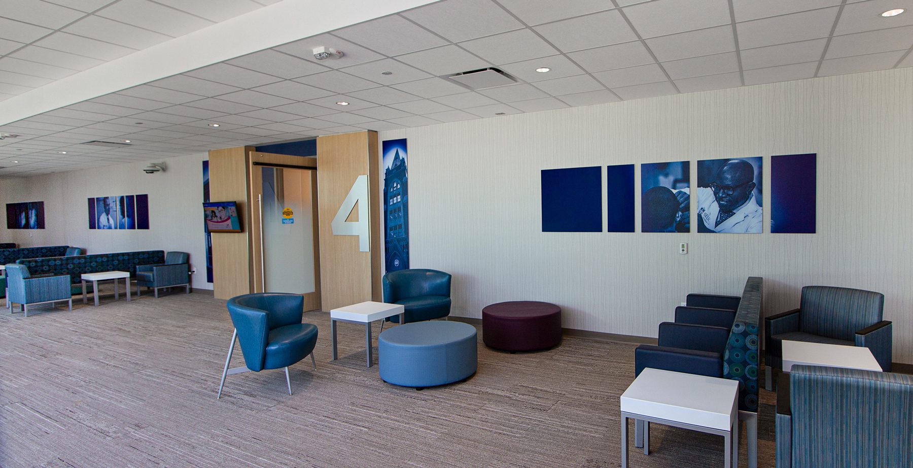 Hospital waiting room features branded acrylic art to create a welcoming atmosphere for patients and visitors.