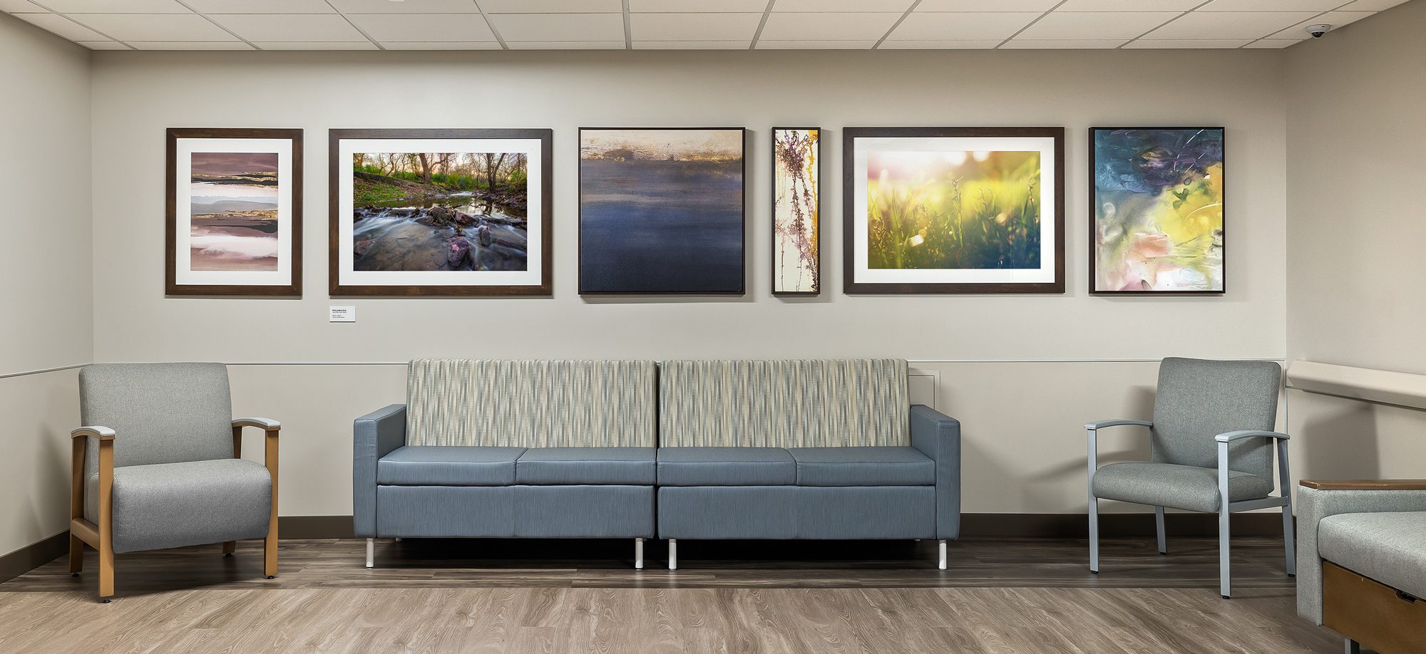 Framed nature photography and canvas artwork displayed in a healthcare clinic waiting room.