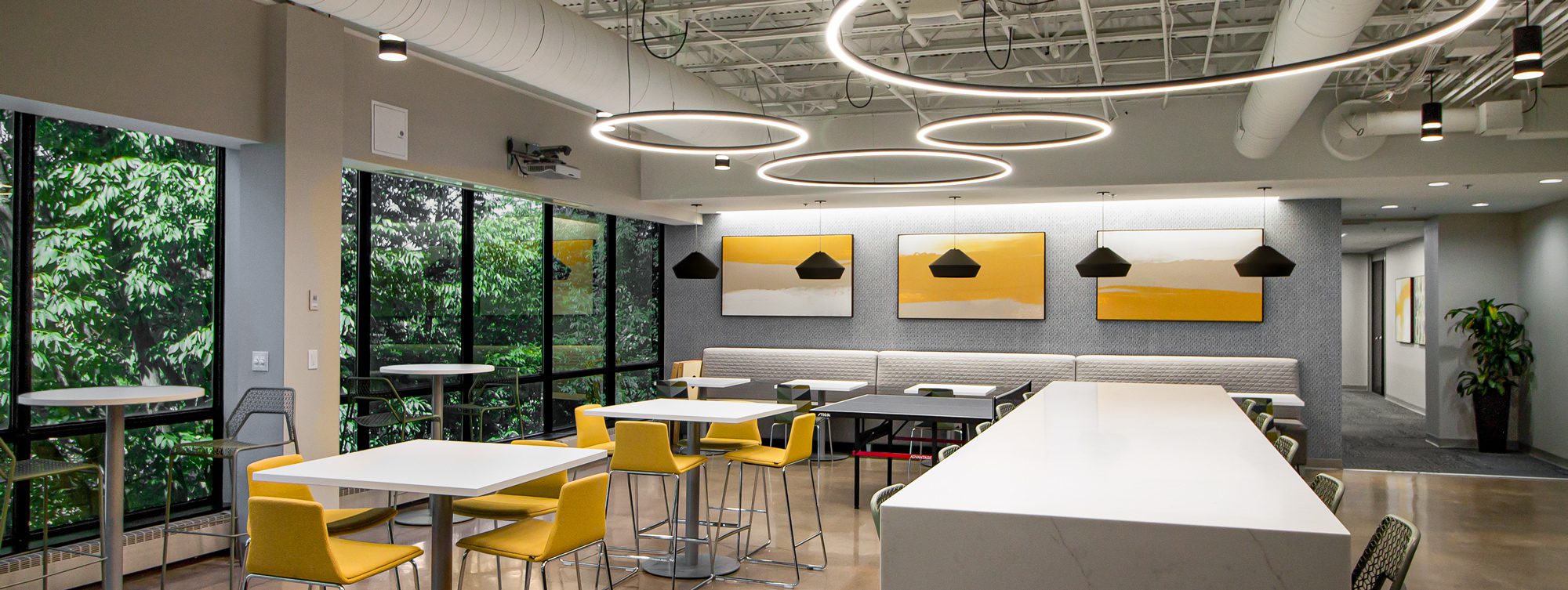 The breakroom in a corporate office features abstract canvas art to enhance the workplace atmosphere.