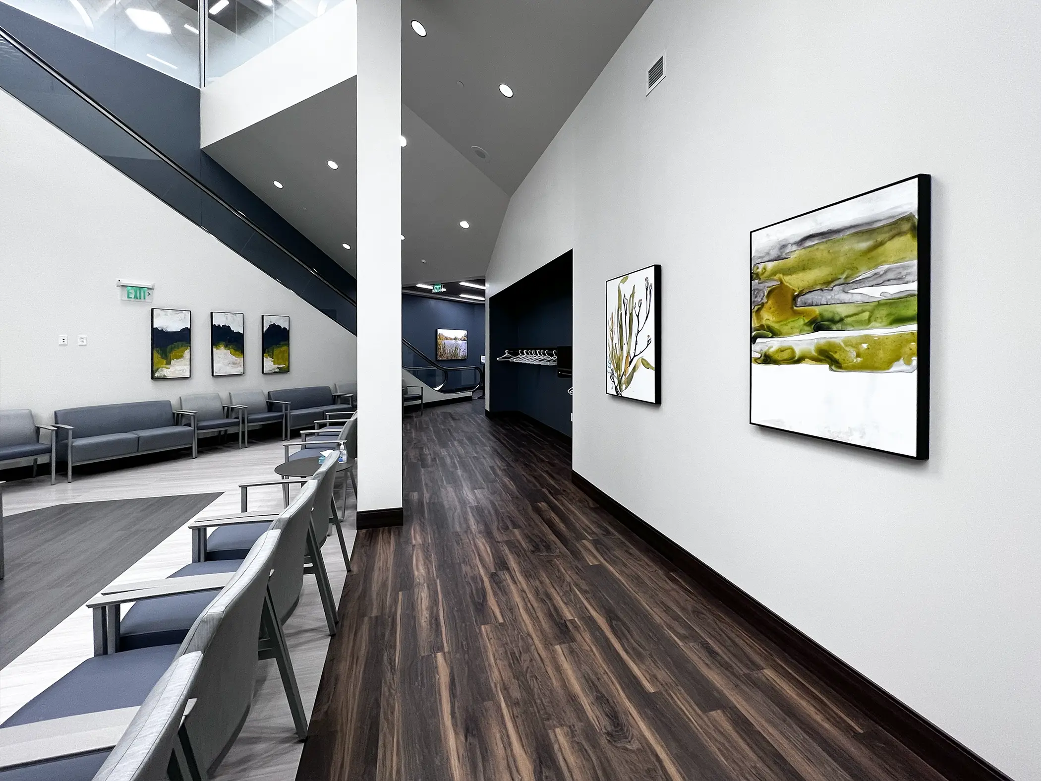 A medical center waiting area features abstract float-framed canvas art to enhance the modern interior.