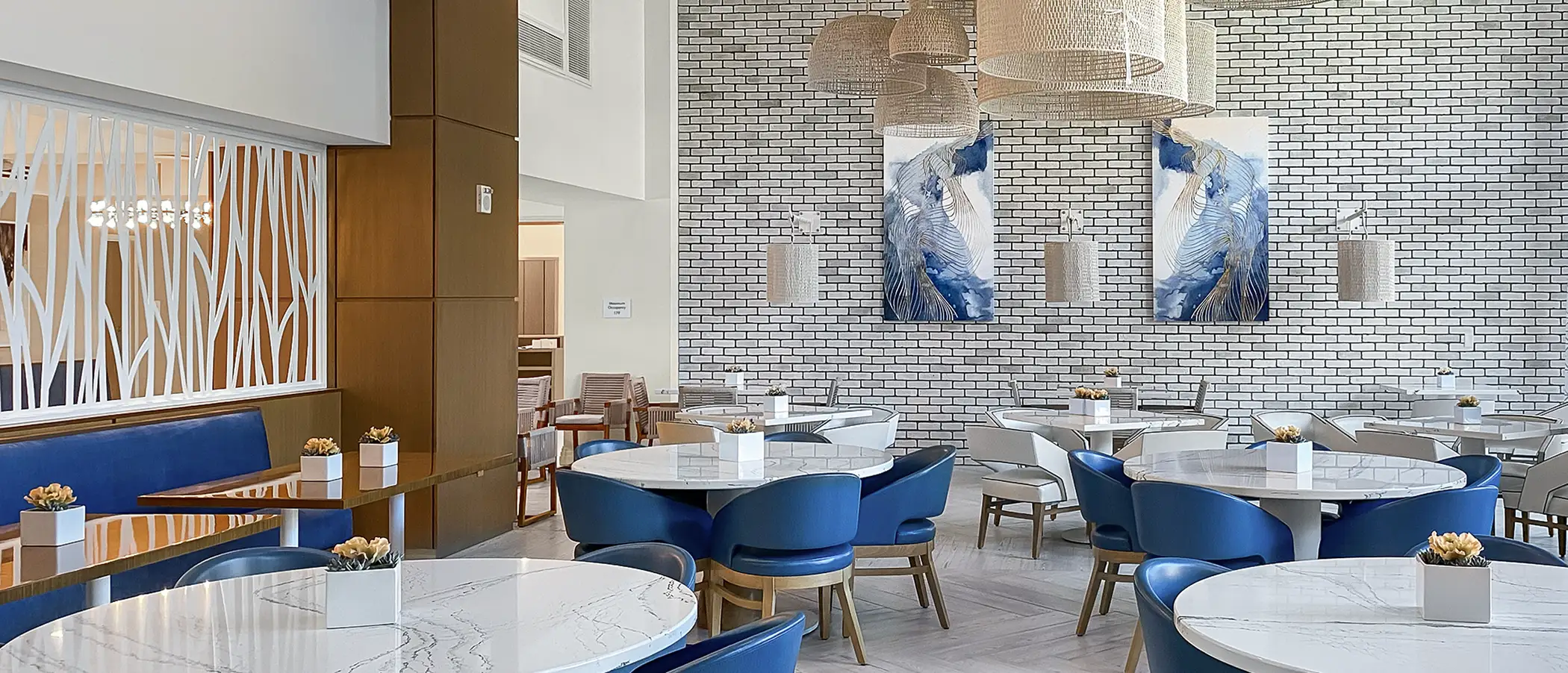 This modern senior living dining space features acoustic art to reduce excess noise and echoes.