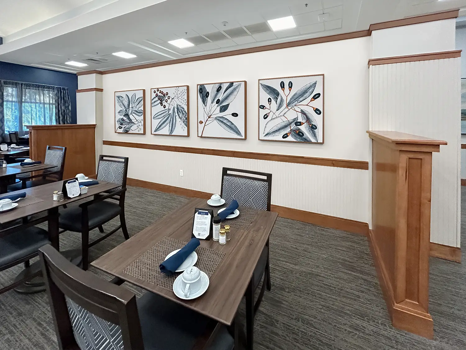 Decorative acoustic panels in this senior living dining space help reduce excess noise.
