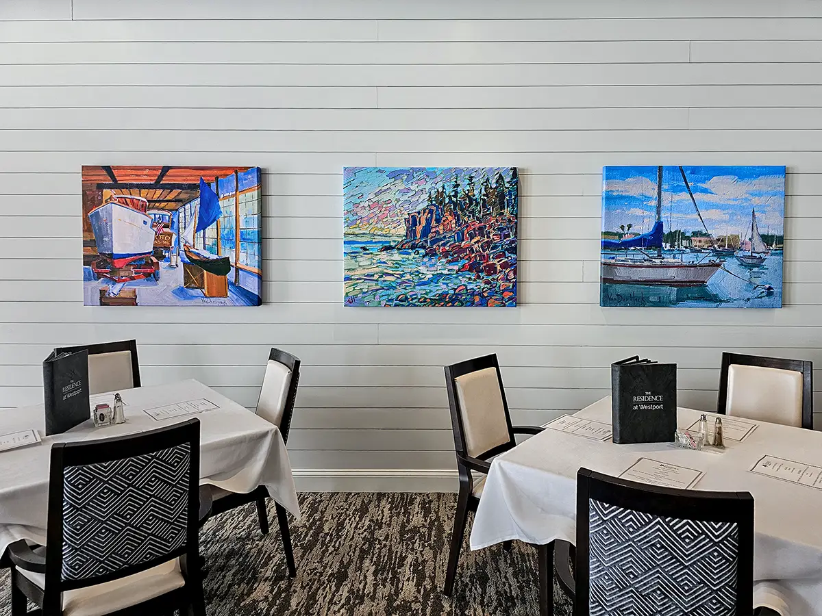 Sound-absorbing art helps manage excess noise in an assisted living dining space, supporting clearer conversations in a shared social setting.