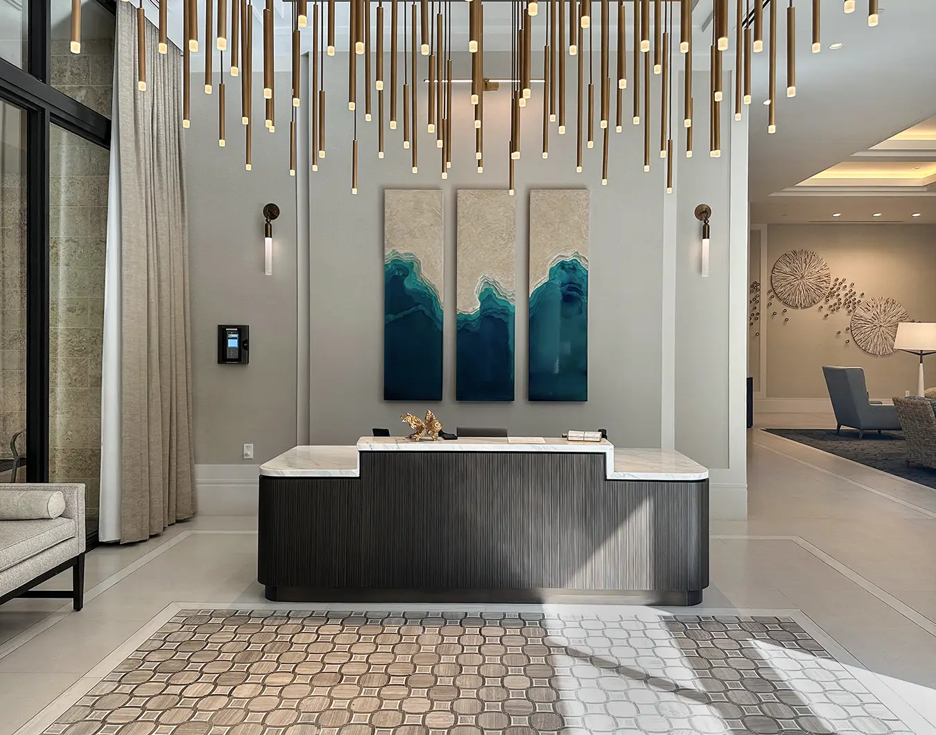 Custom dimensional art behind a senior living reception desk adds vibrant color and texture to the space.